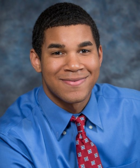 A professor in a blue button down shirt with a red patterned tie.  The professor is Dr. Wyatt Dawson,