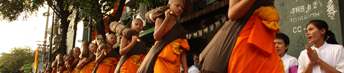 Buddhist monks walking down a street