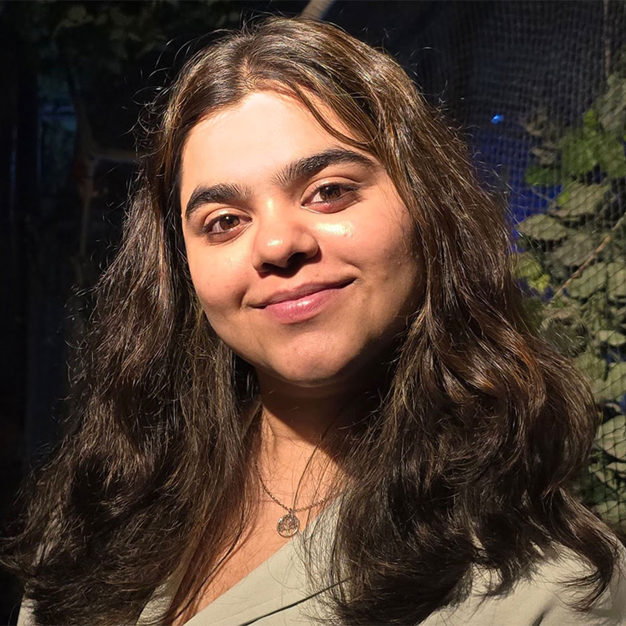 Abhilasha Talwar smiles for the camera in a close up portrait.