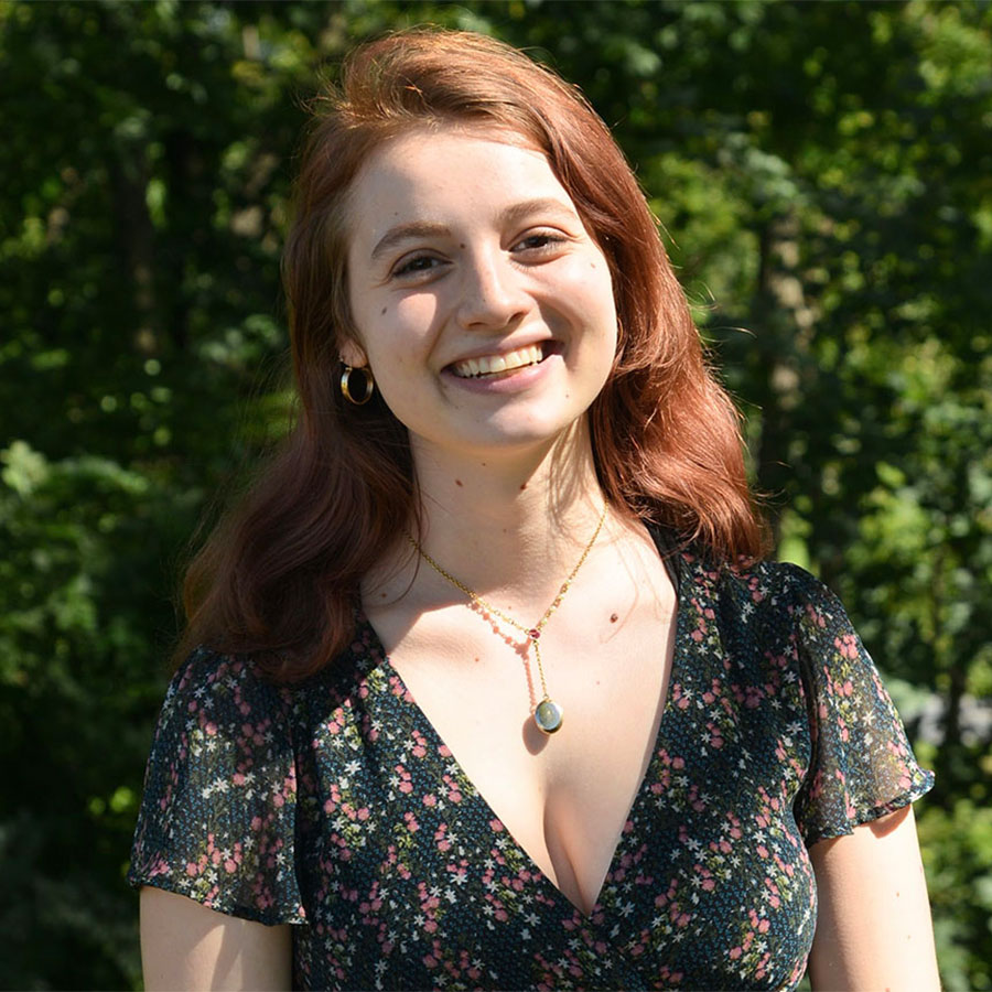 Smiling college student Sophie Tomov poses outdoors.