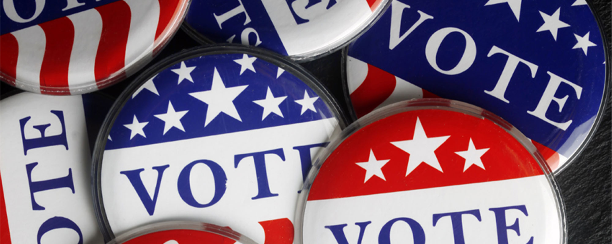 A collection of red, white and blue buttons that read 