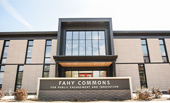 The front of a modern building with a sign that reads 