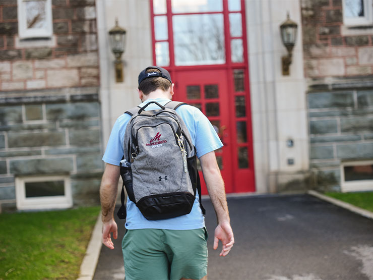 A student with a backpack that reads 