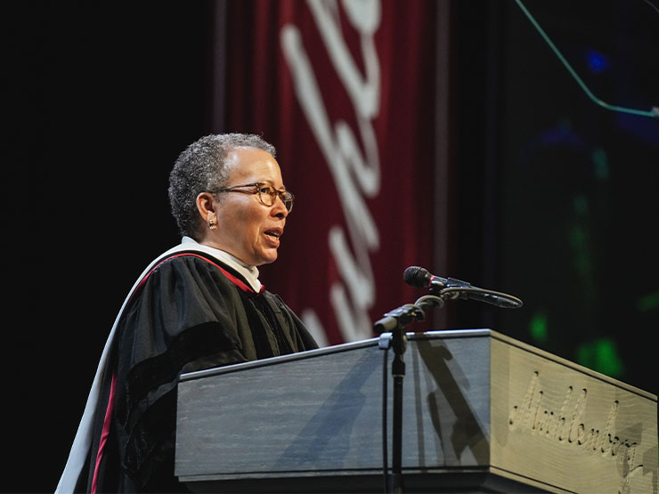 Beverly Tatum speaks at a podium during a Muhlenberg College commencement ceremony.