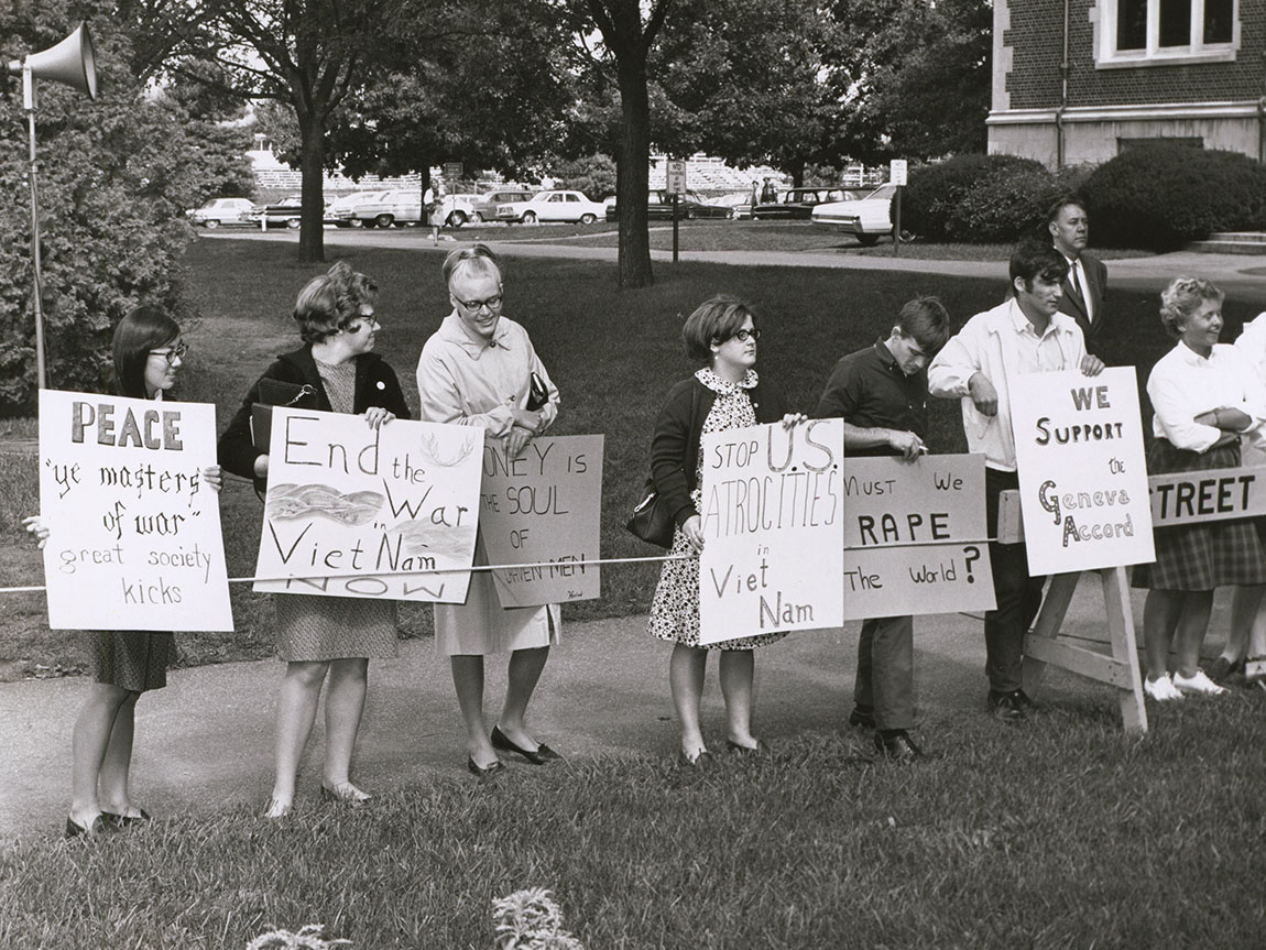 A black and white photo of campus protestors in 1966